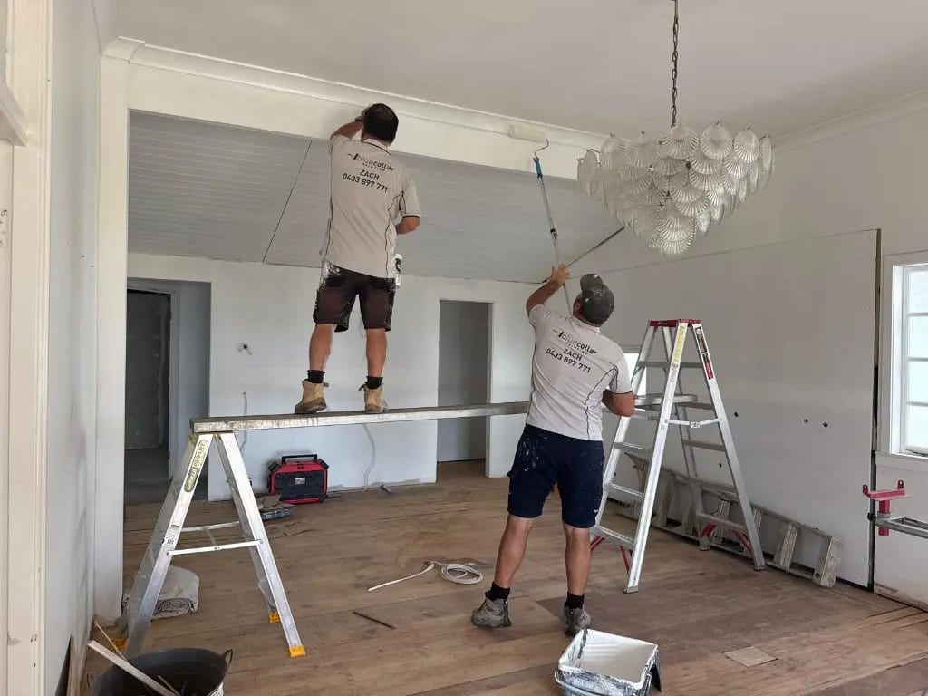 Professional painters completing interior ceiling painting inside a Gold Coast strata complex
