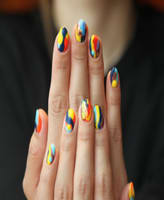 A customer with colorfully painted nails