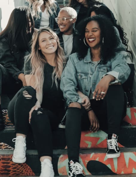 Happy students sitting on a flight of stairs