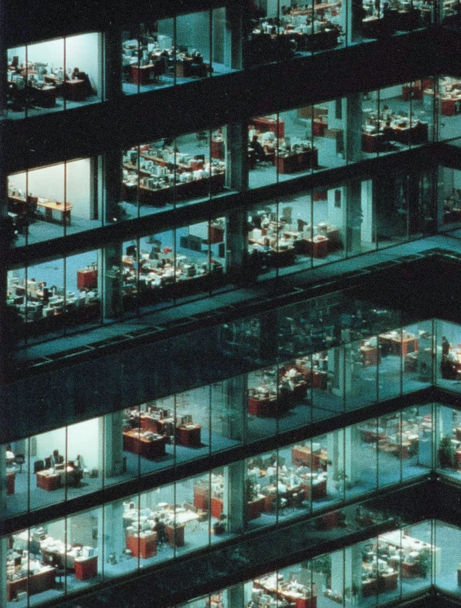 A view from above of a modern office building with glass walls and multiple floors.