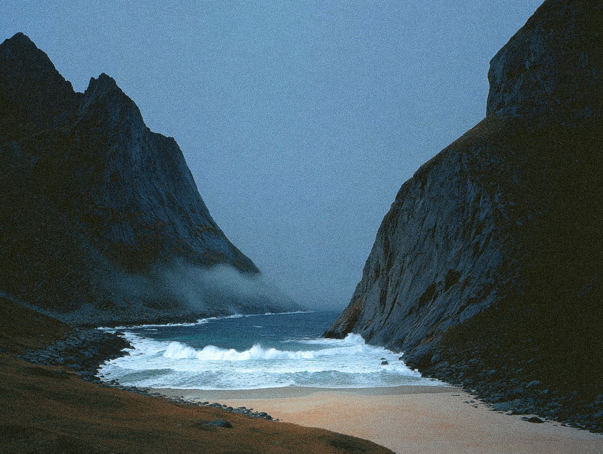 A rugged coastal landscape with towering cliffs and a sandy beach, under a misty sky.