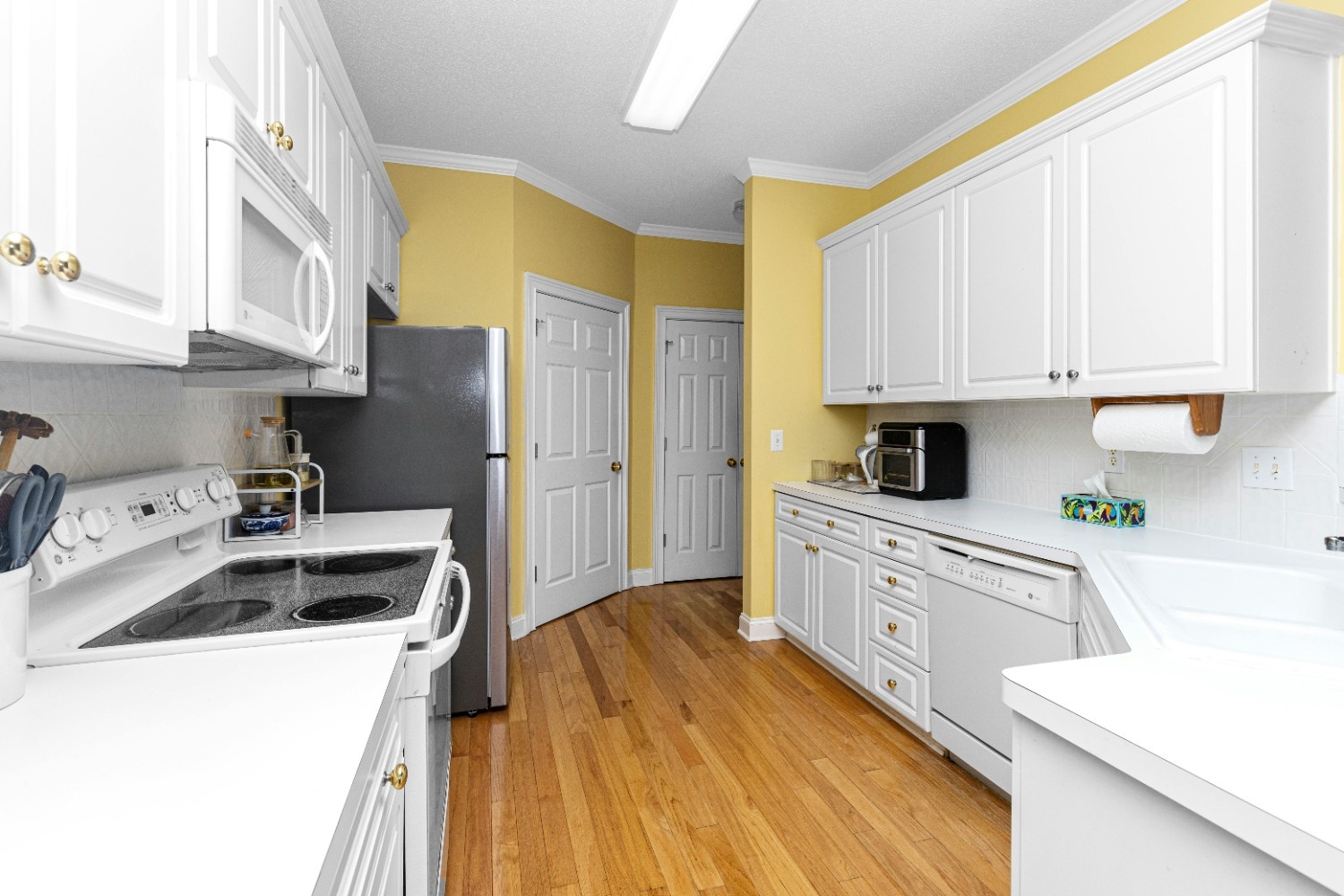 Kitchen corner with yellow cabinets and patterned backsplash