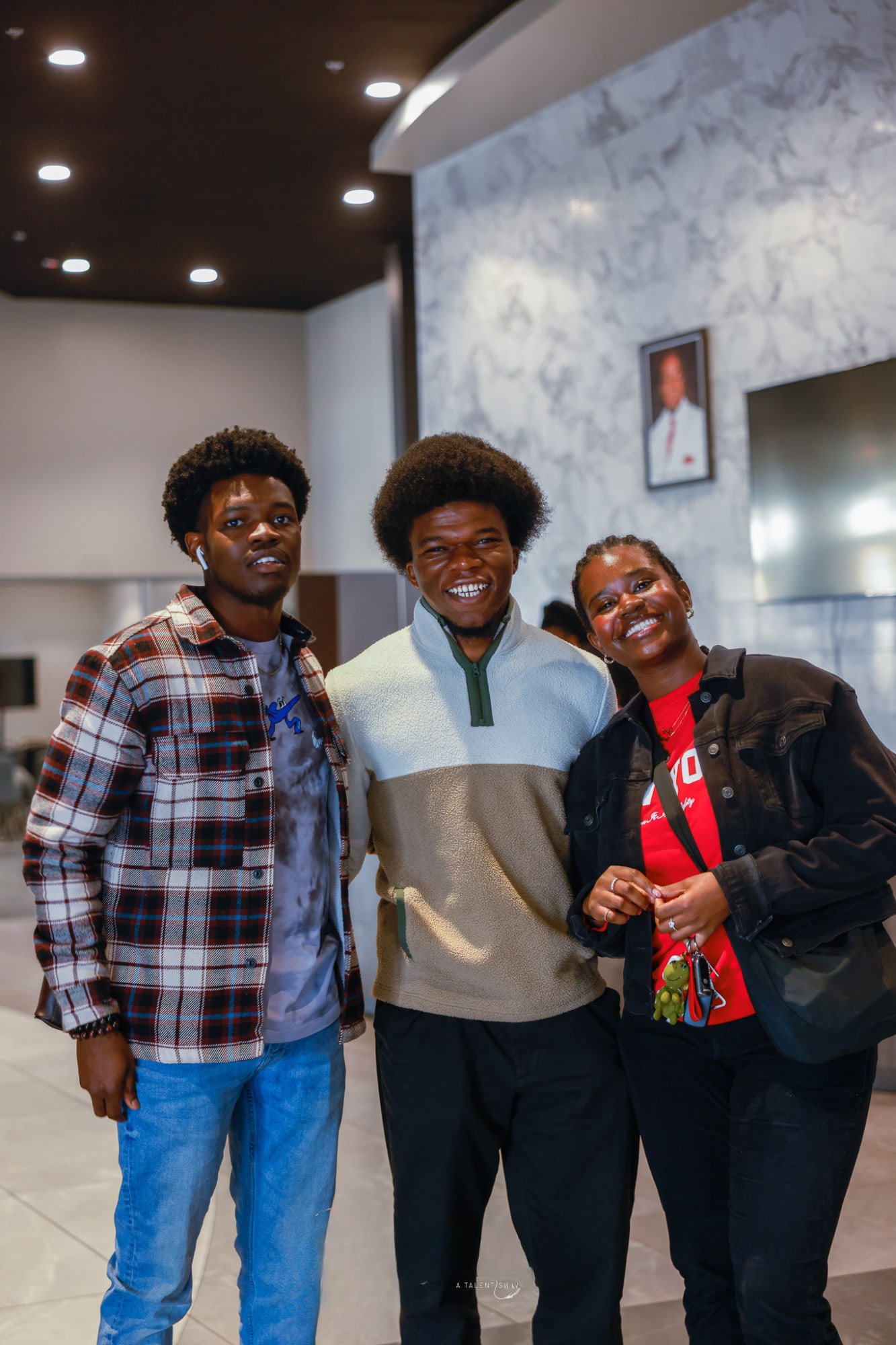 Three friends smiling together at YAF USA