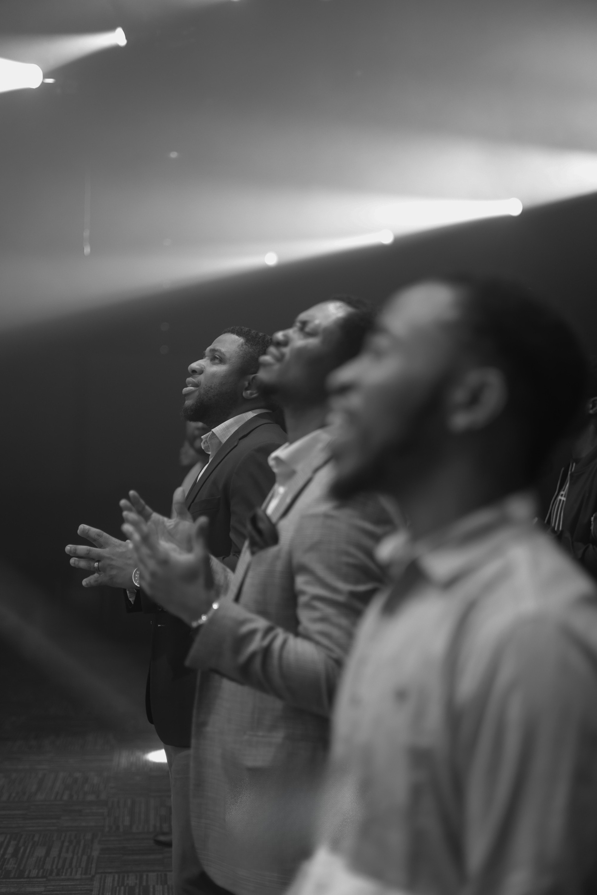 Men worshipping in black and white