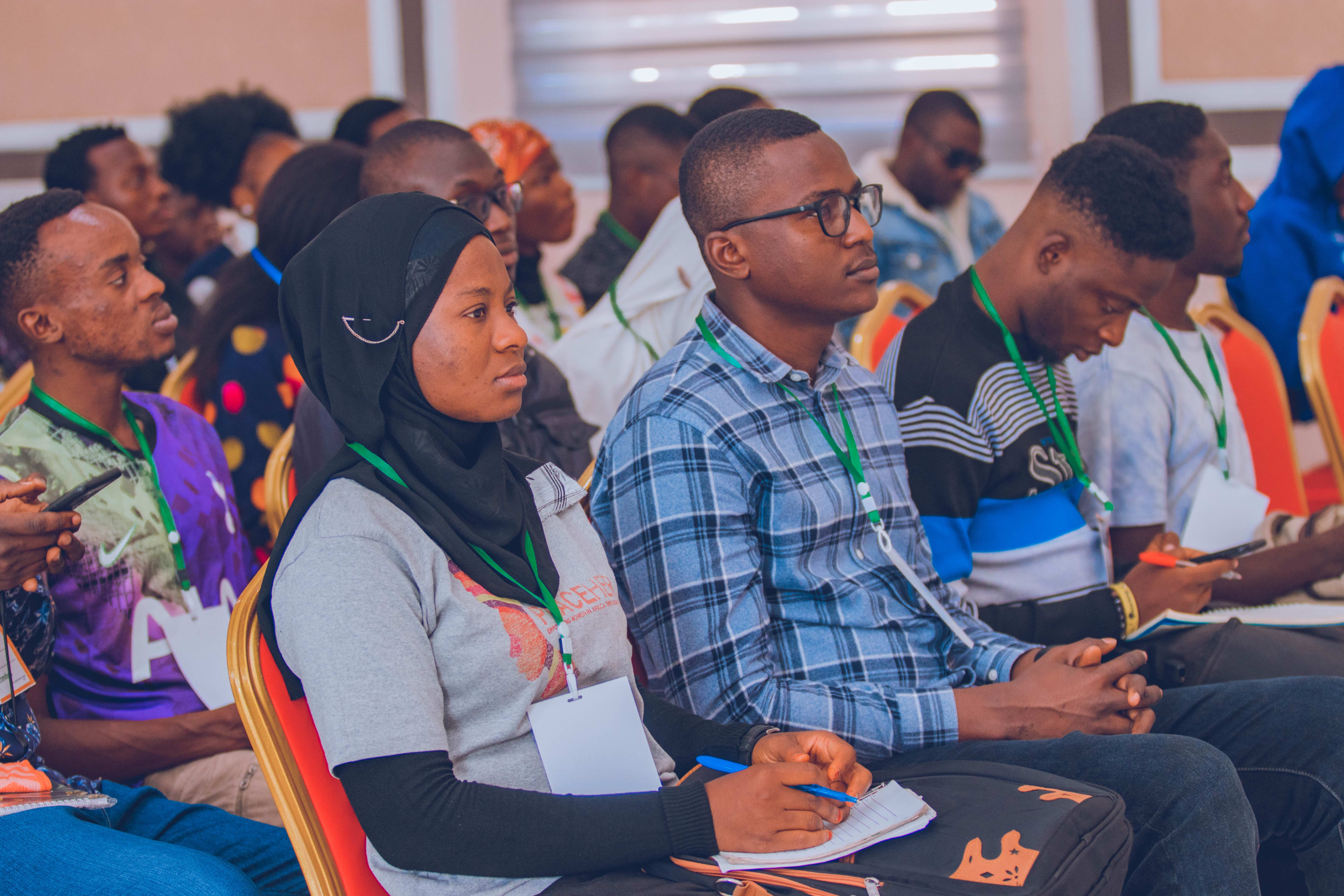 Attendees taking notes during a session