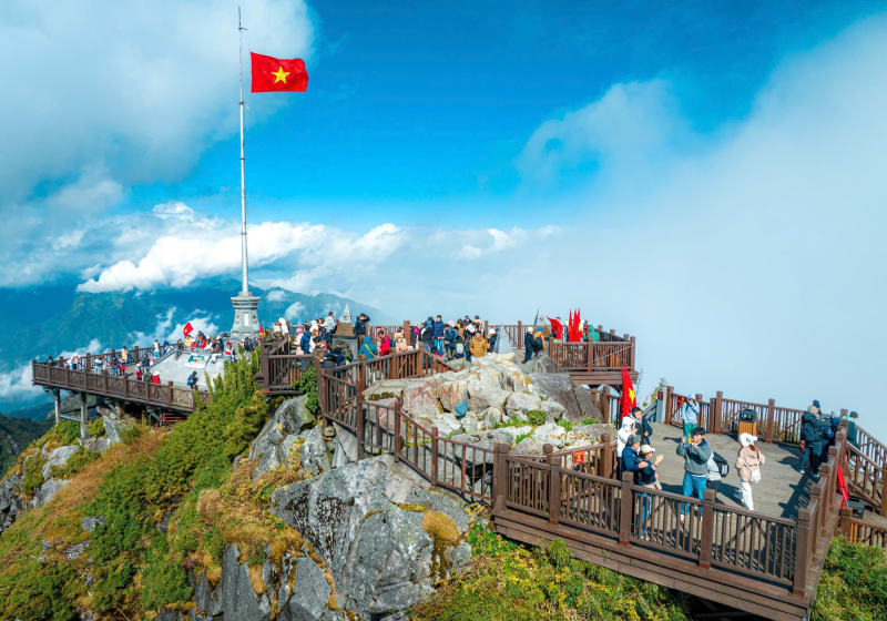 The Fansipan summit platform and flagpole on a blue-sky day