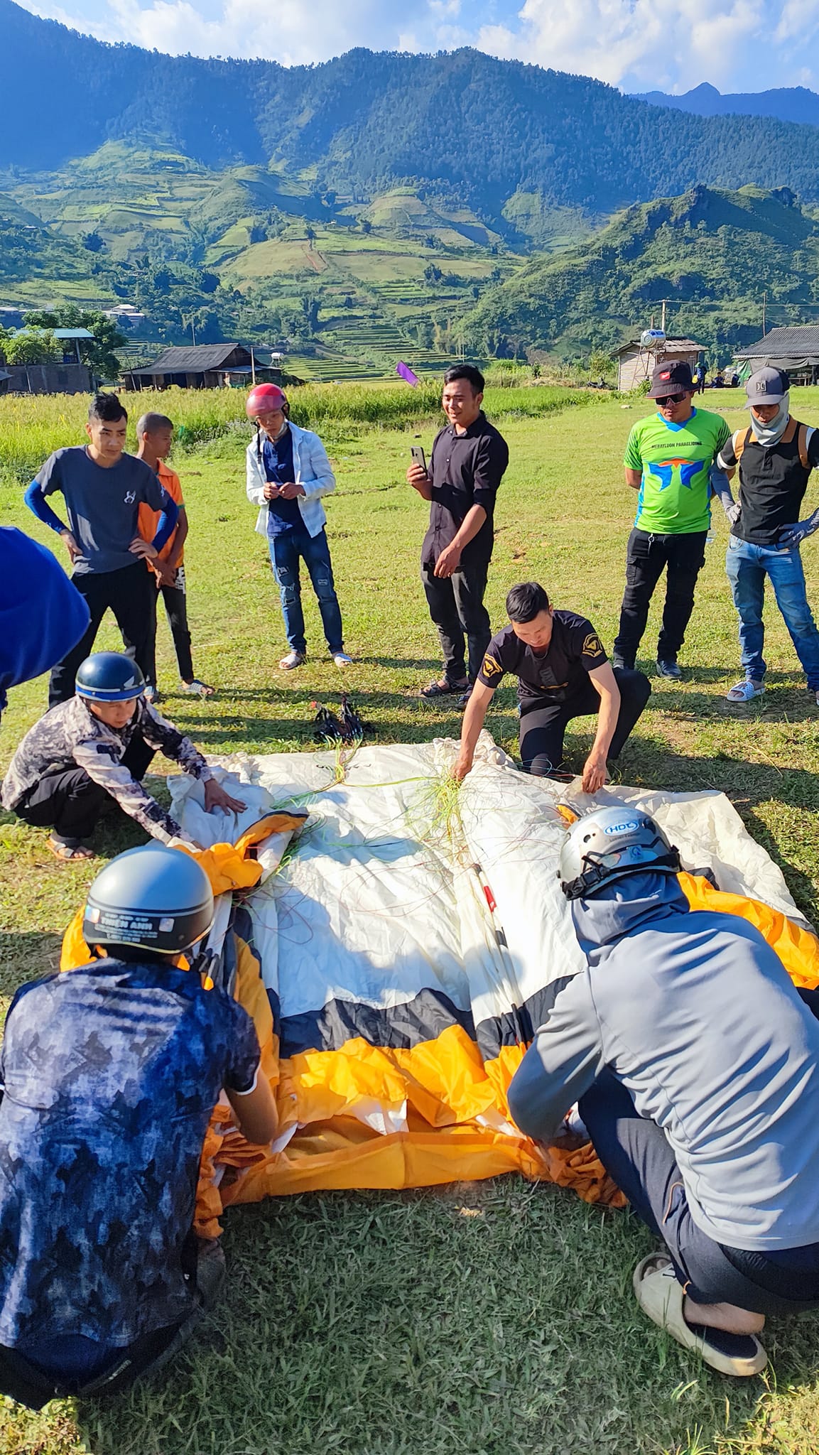Instructor showing students the correct way to fold a paraglider