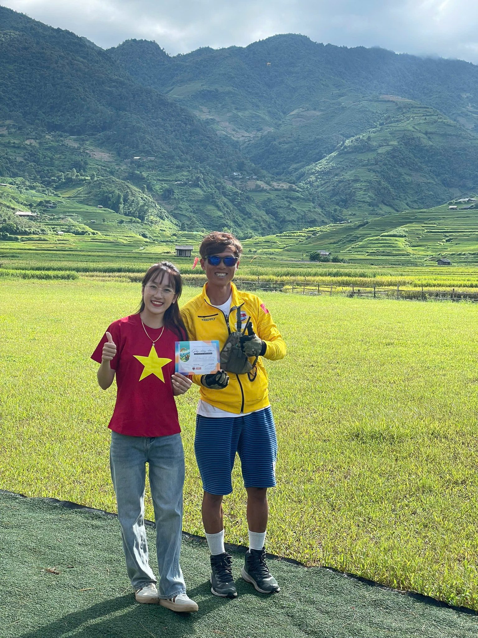 A student and a pilot at the landing field after a flight