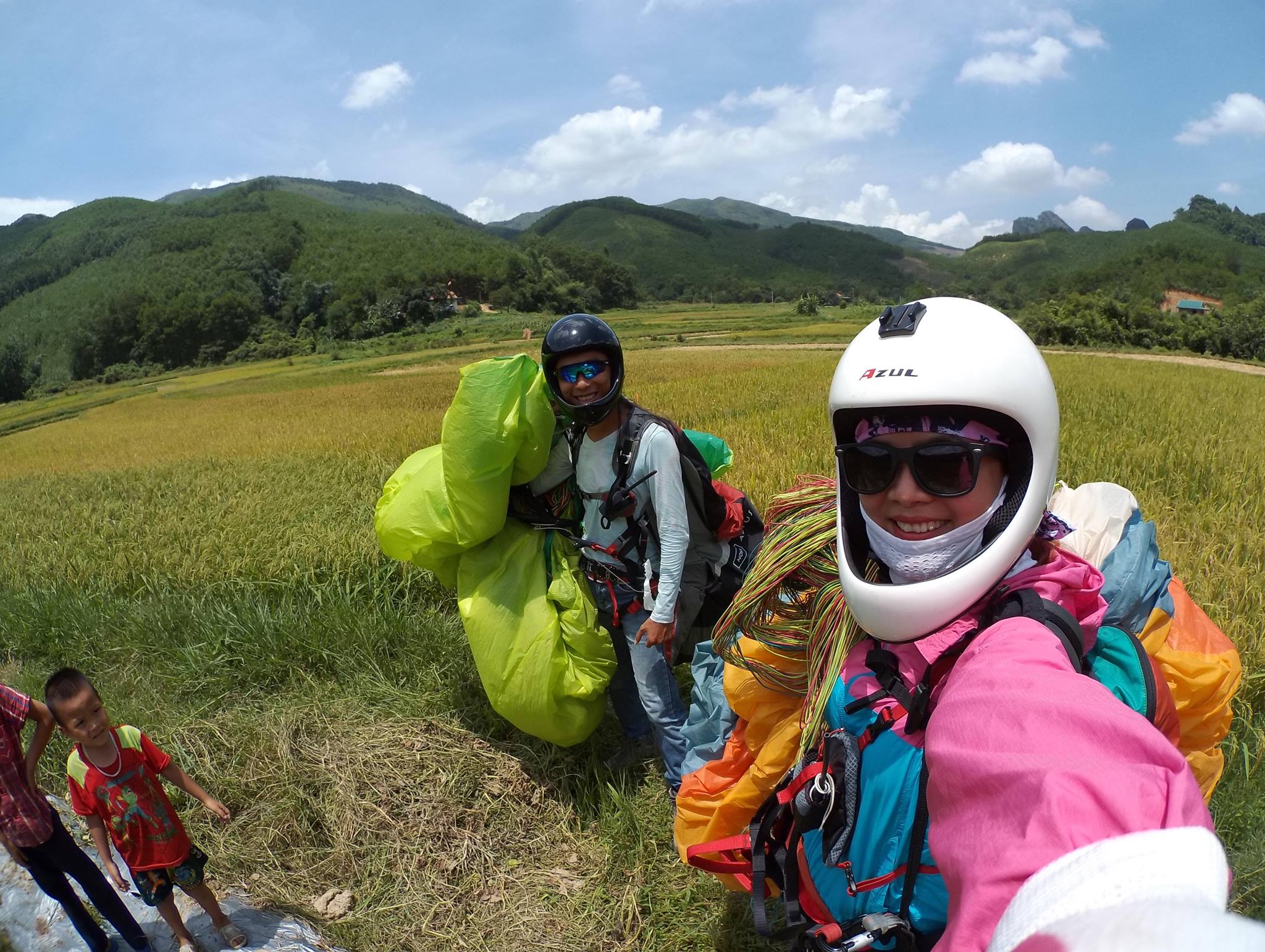 A paraglider pilot touching down at the landing field
