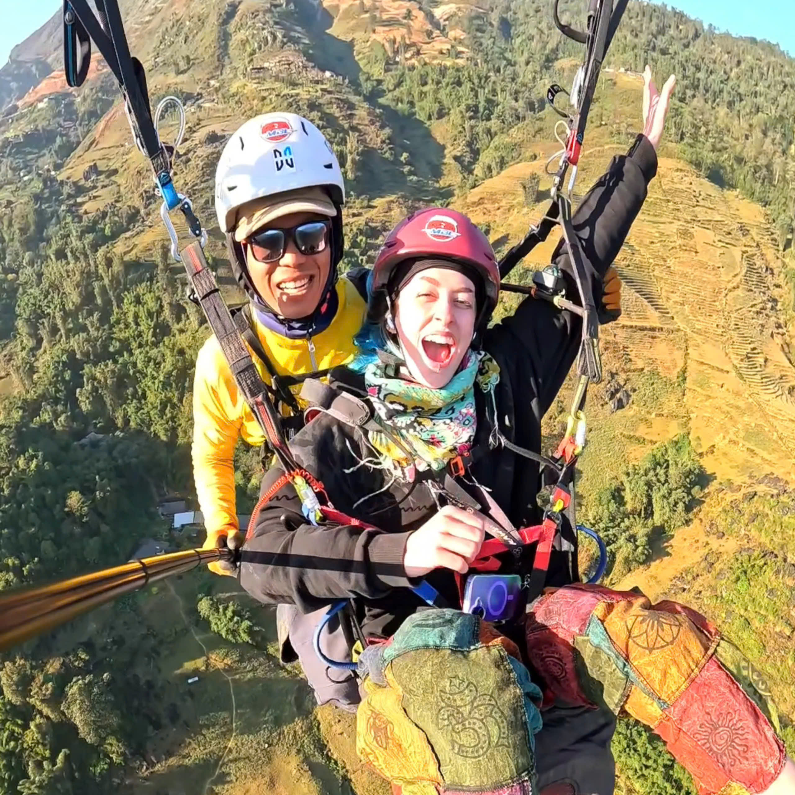 Passengers cheering during a paragliding flight over Sapa