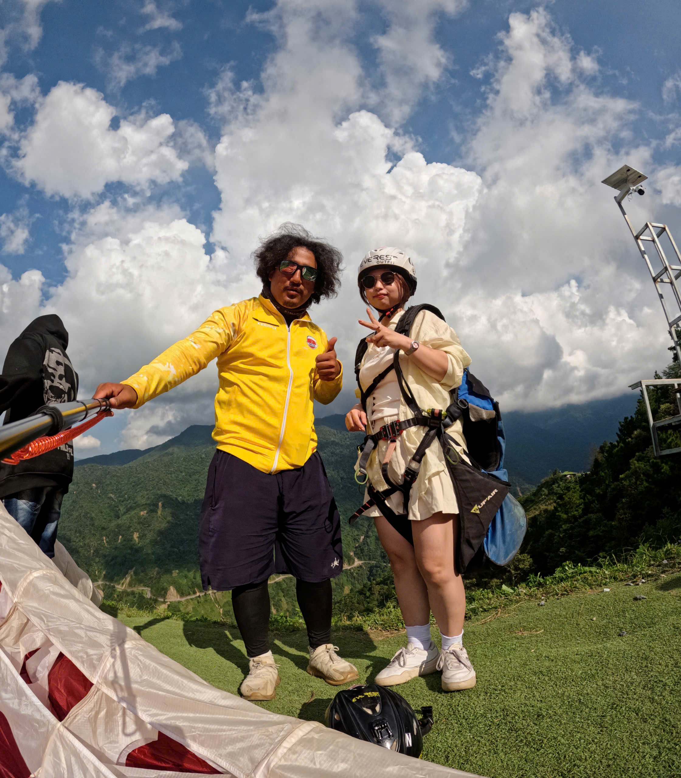 Passengers taking photos at the Sapa paragliding launch site