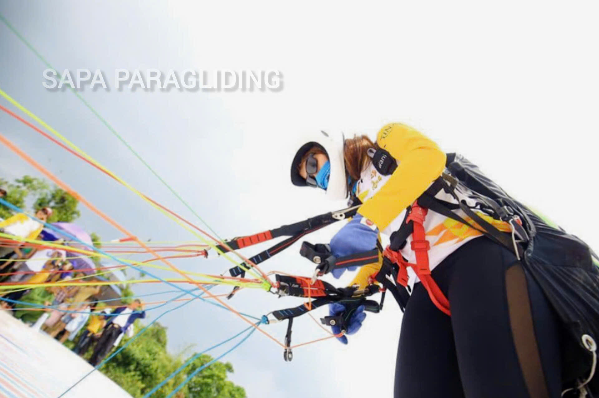 A female pilot checking her paraglider lines before flying