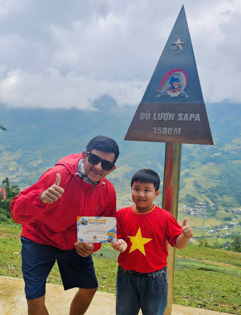 A young child after completing a tandem paragliding flight in Sapa