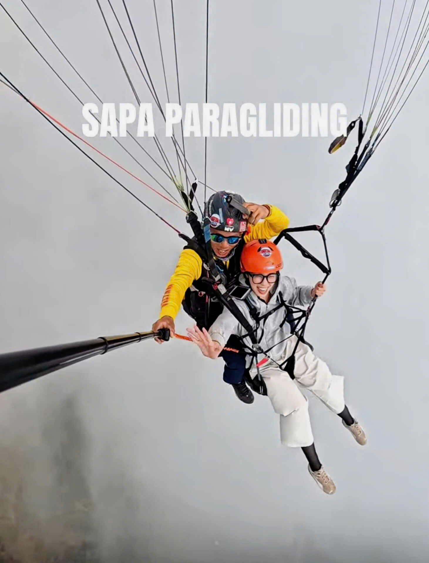 Early morning paragliding above a sea of clouds in Sapa