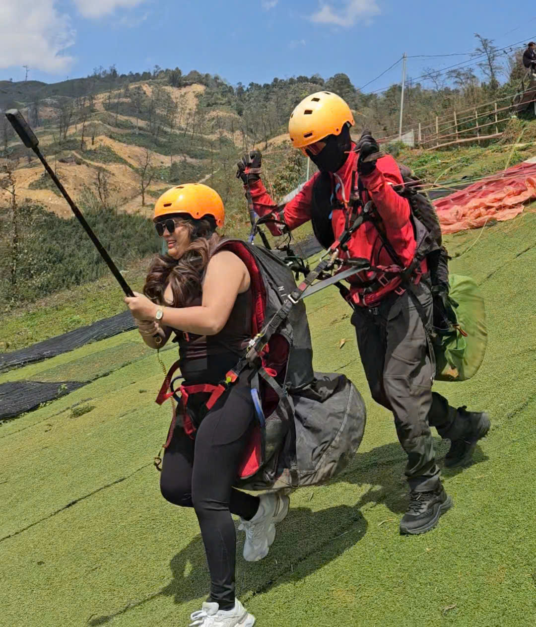 Pilot and passenger running for take-off at the Sapa paragliding site