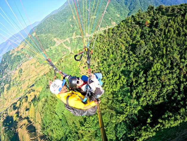 Paragliding over the water-pouring season at Lim Thai village, Tu Le
