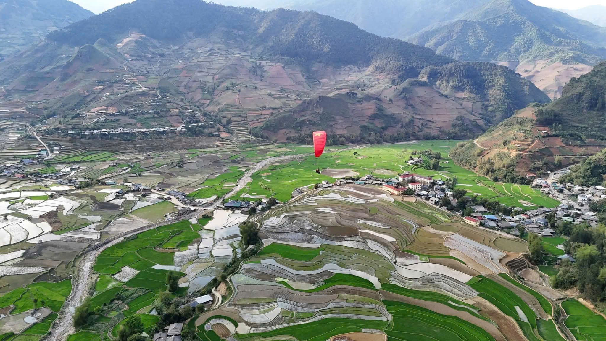 Mu Cang Chai terraced fields in the water-pouring season seen from a paraglider