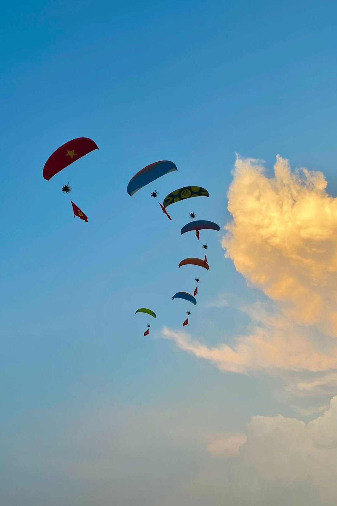 Banner quảng cáo treo phía dưới dù lượn trong một sự kiện ngoài trời.