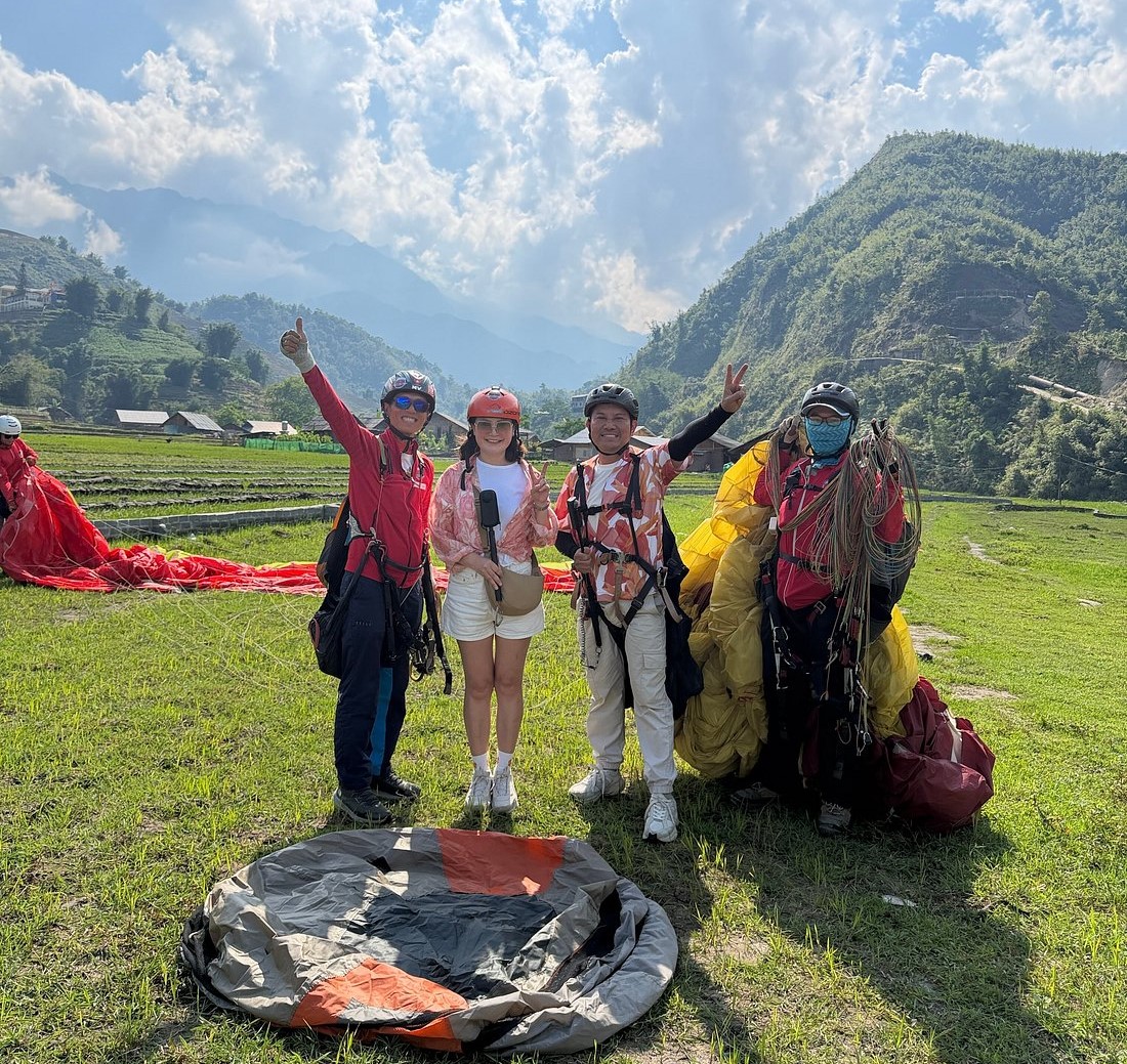Passenger flying tandem with a professional paragliding pilot over Sapa