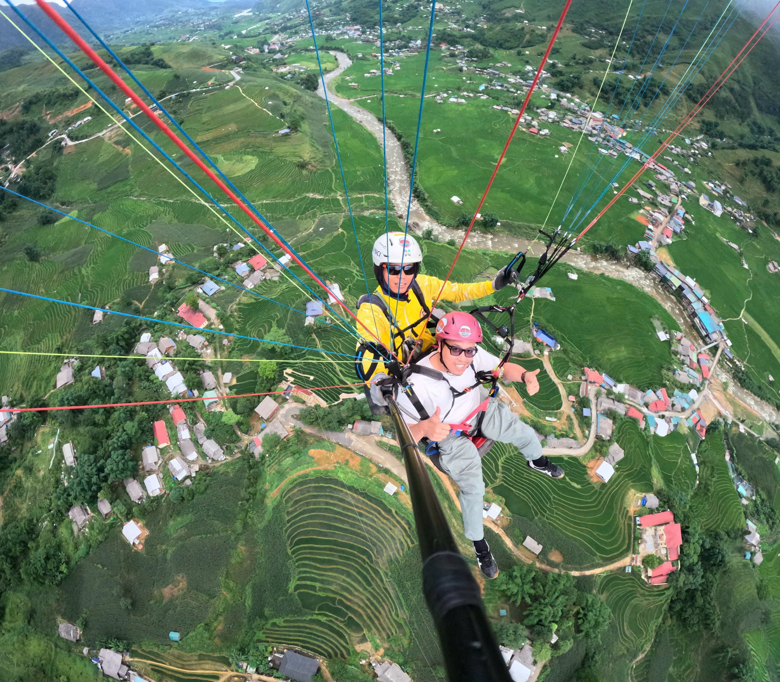 Selfie of a tandem flight high above the valley and villages of Sapa