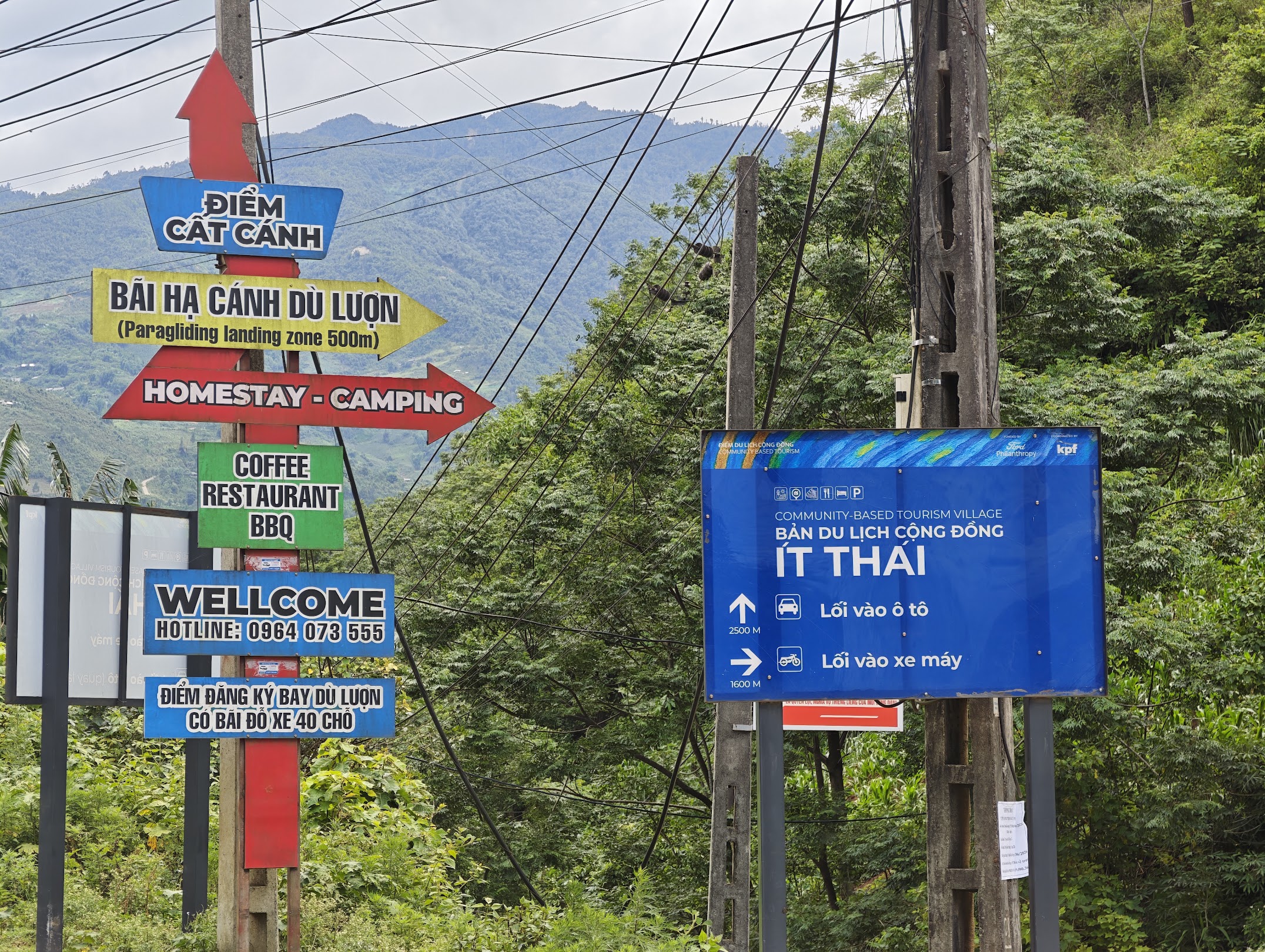 Ban Lim junction - with a sign pointing down to the paragliding landing zone