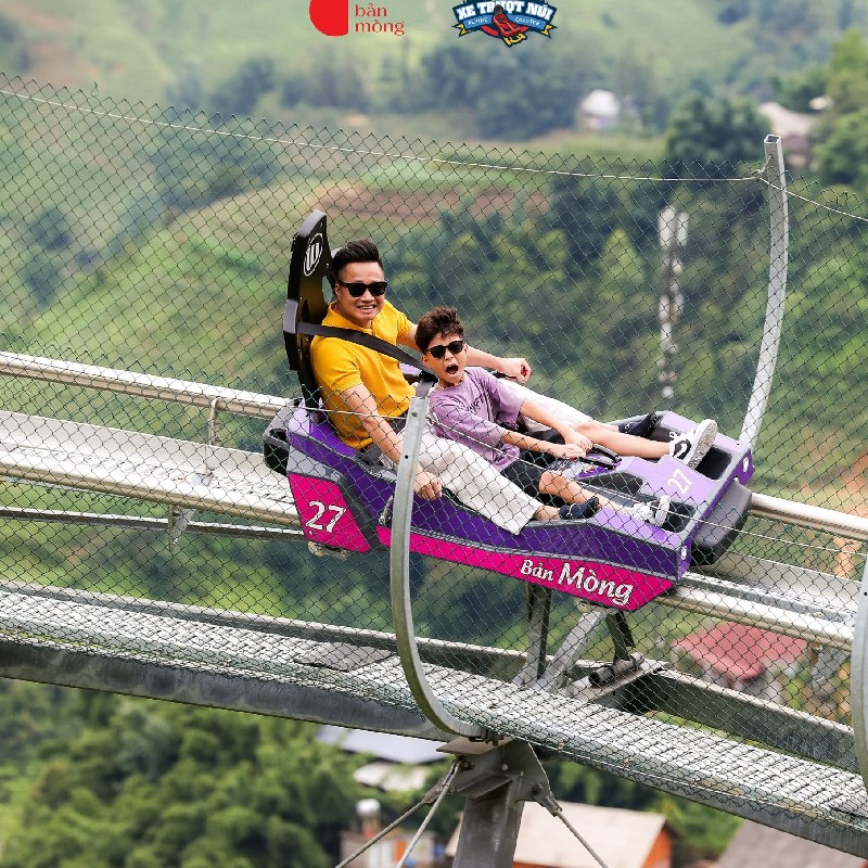 Tourist driving an alpine coaster down the hillside in Ban Mong