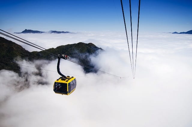 Fansipan cable car cabin floating above a sea of clouds in Sapa