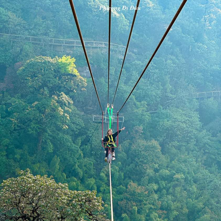 Tourist experiencing a heart-stopping sky cycling ride above the clouds in Sapa"
