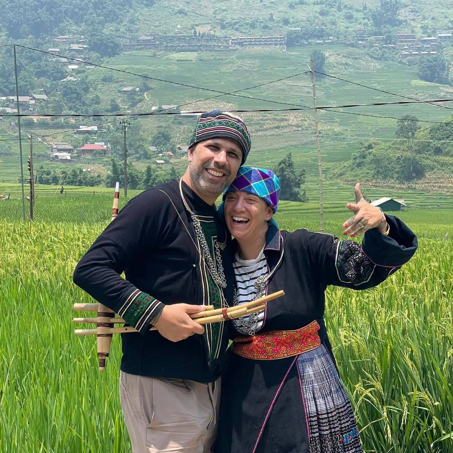 Tourists wearing traditional ethnic clothing in Sapa, Vietnam, experiencing the local culture and exploring the beautiful villages and terraced rice fields of the Muong Hoa Valley