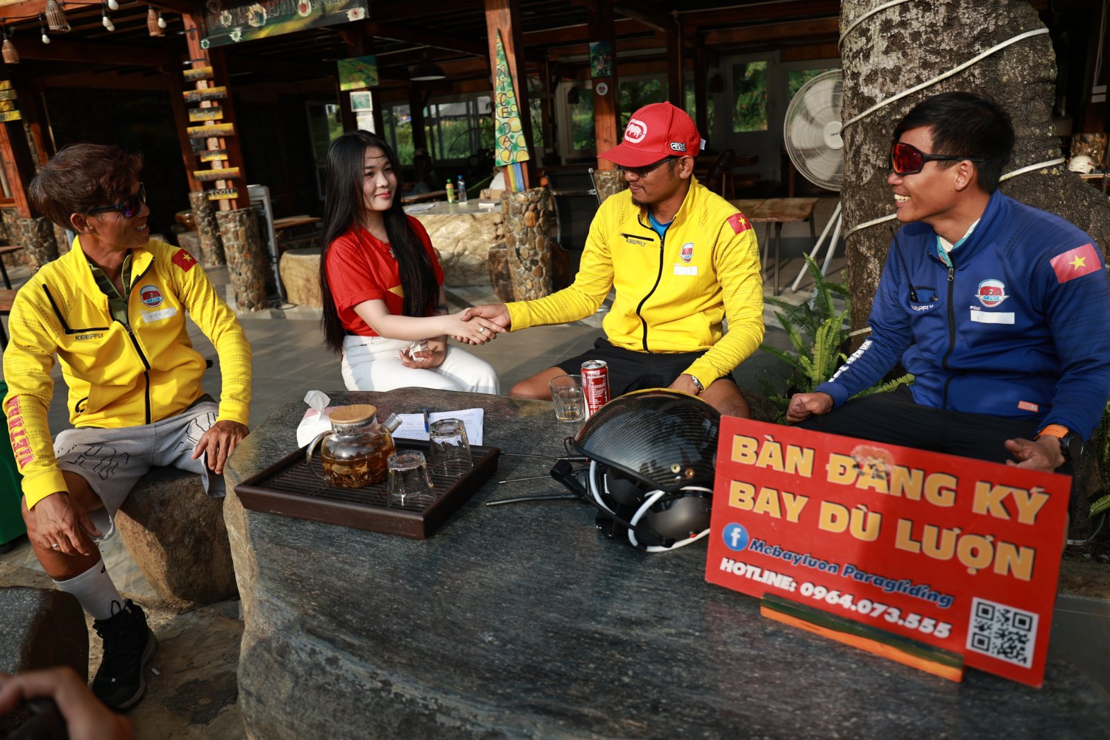 The paragliding registration desk at Khau Pha — guests meet their pilot and get a full briefing before confirming the package