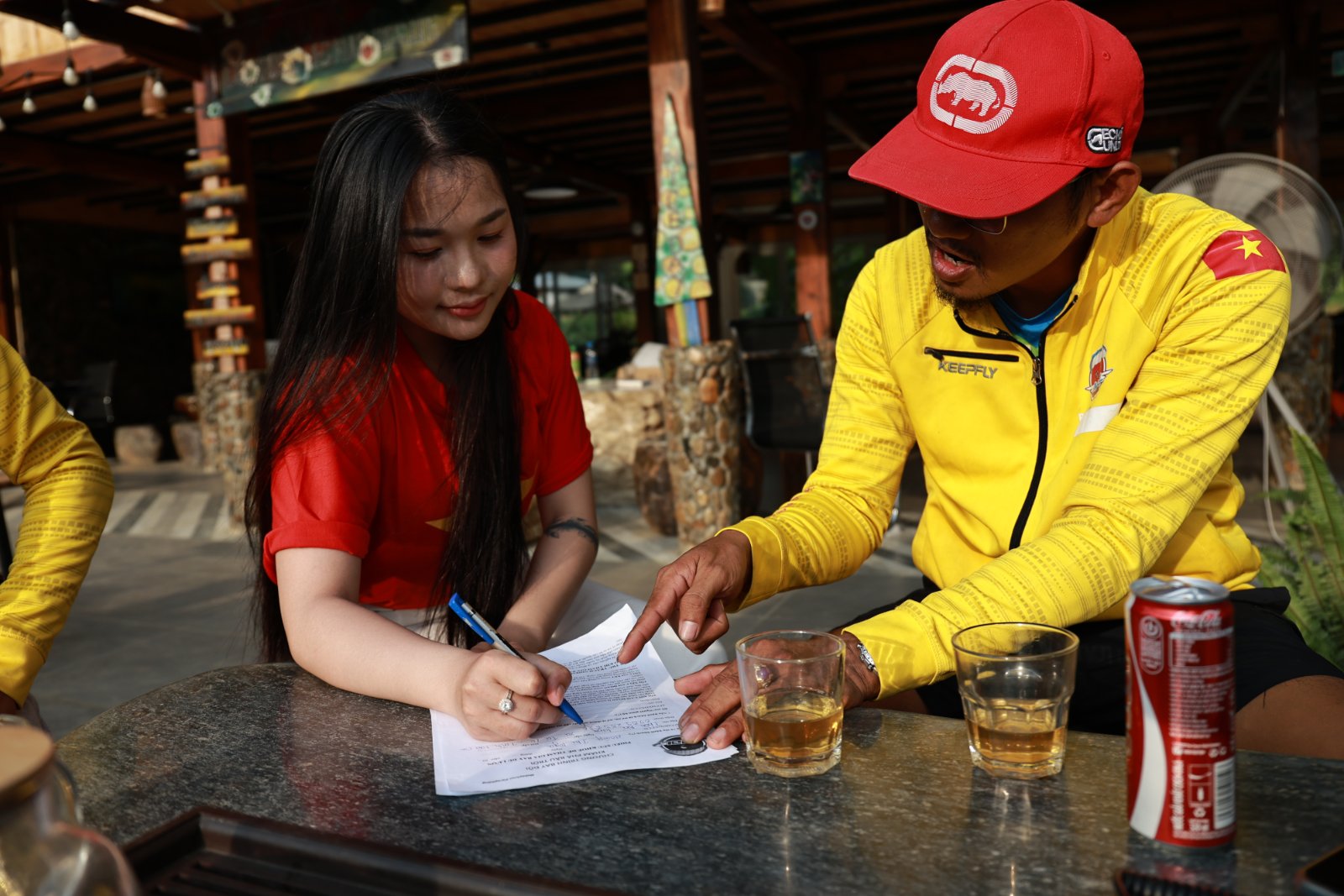 A guest signing the participation conditions while the pilot explains each point
