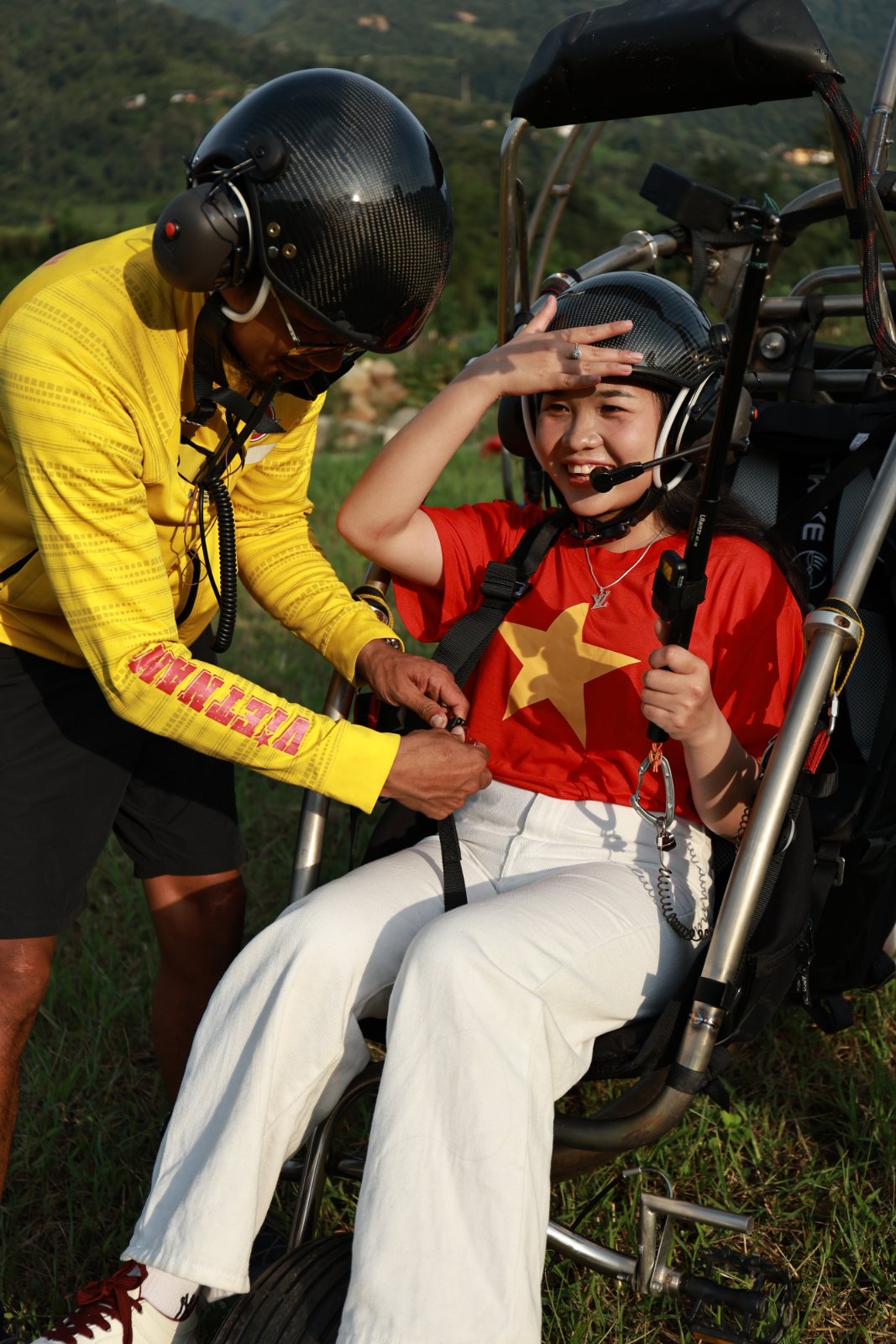 The pilot personally fitting and checking every buckle of the passenger harness before launch