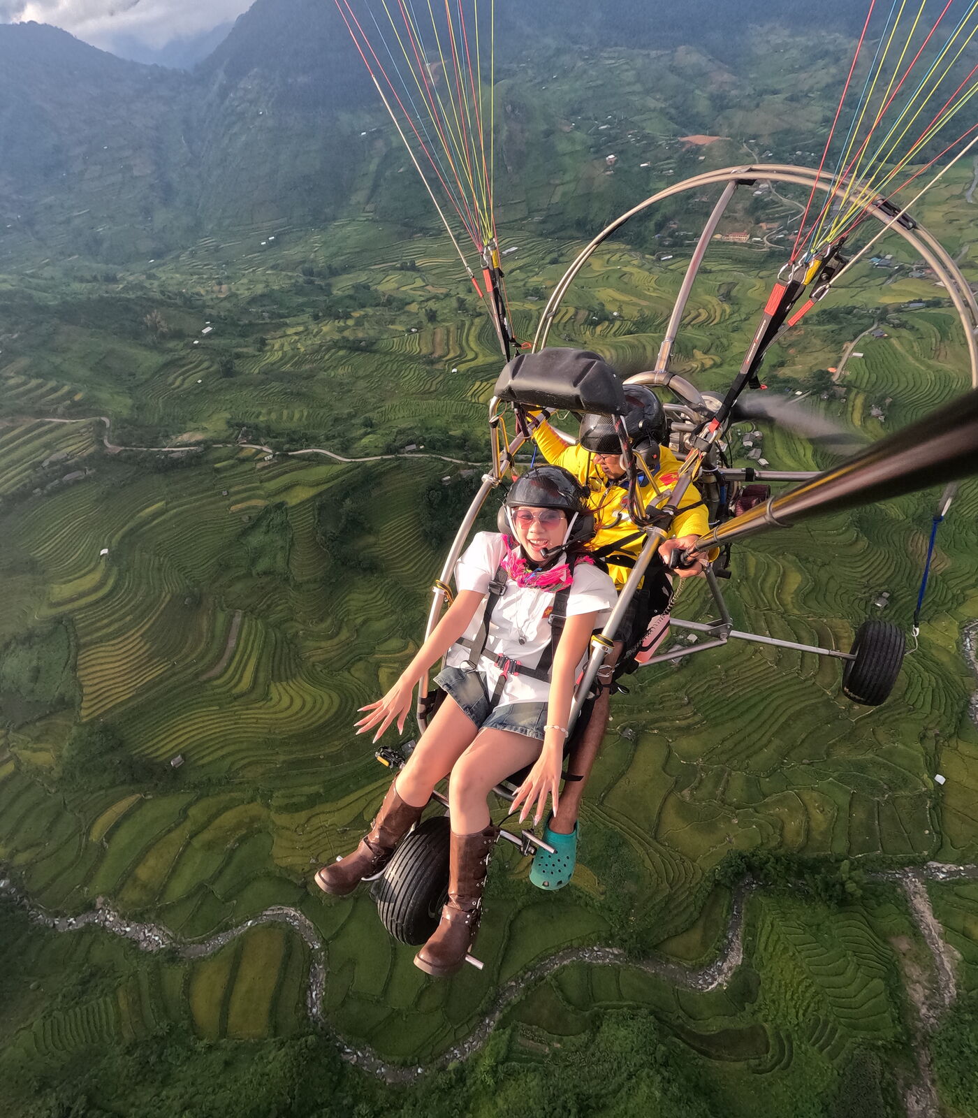 A guest seated comfortably on the trike, flying over the Mu Cang Chai rice terraces