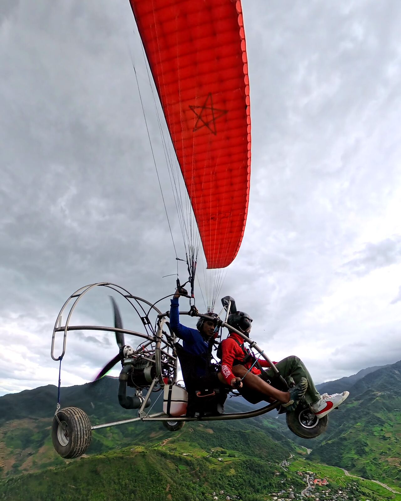 Looking up: the red wing and the trike in the Mu Cang Chai sky