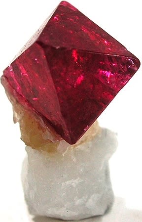 Spinel crystals associated with calcite, as labelled by the source.