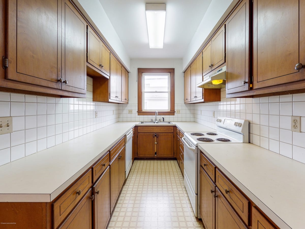 Worn kitchen cabinets before refinishing