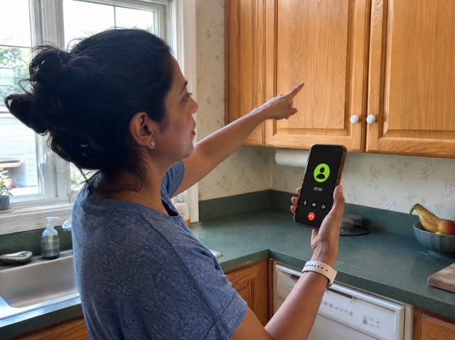 A homeowner doing a video walkthrough of their kitchen cabinets for the Jerry & Co. remote estimate