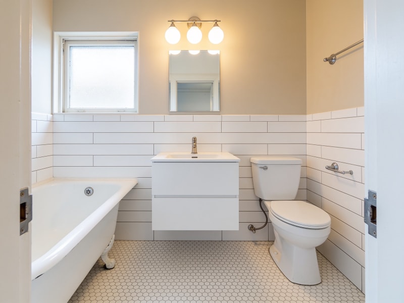 Cambridge condo bathroom after gut-free refresh with white subway tile and new vanity