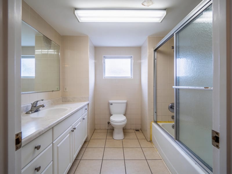 Everett condo bathroom with original dated beige tile before bathroom refresh