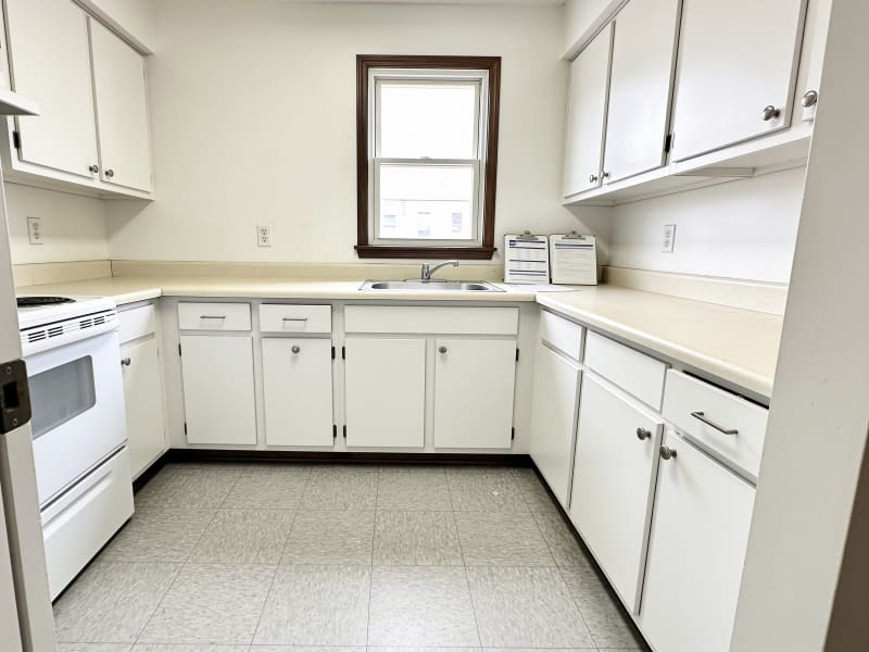 Malden multi-unit rental kitchen after cabinet refinishing in bright white matte finish