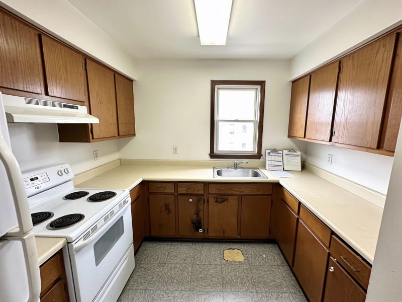 Malden multi-unit rental kitchen with builder-grade oak cabinet doors before refinishing