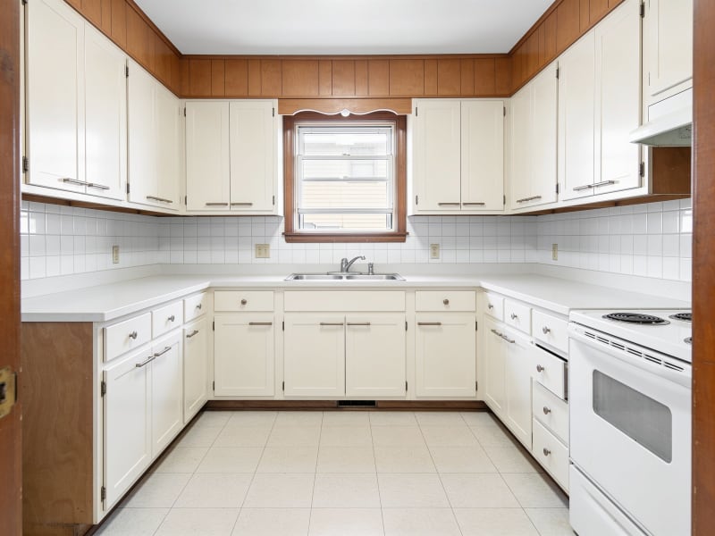 Medford condo kitchen after cabinet refinishing in warm bone white matte finish