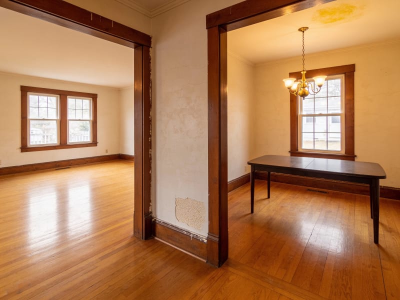 Woburn colonial home living and dining room with aged paint before repainting