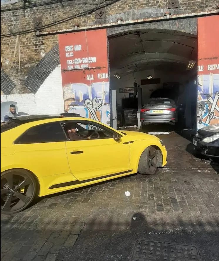 Reliance Autos Bow — yellow Audi RS outside the railway arch workshop