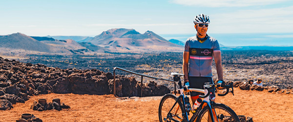 Ciclista in posa su un paesaggio vulcanico a Lanzarote, Canarie.