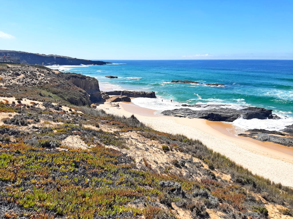 Spiaggia deserta con scogliere lungo la costa dell'Algarve lungo la Rota Vicentina
