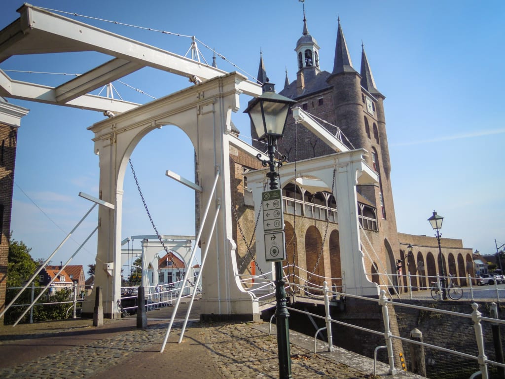 View of a traditional iron bridge with the NEMO Science Museum behind, Amsterdam