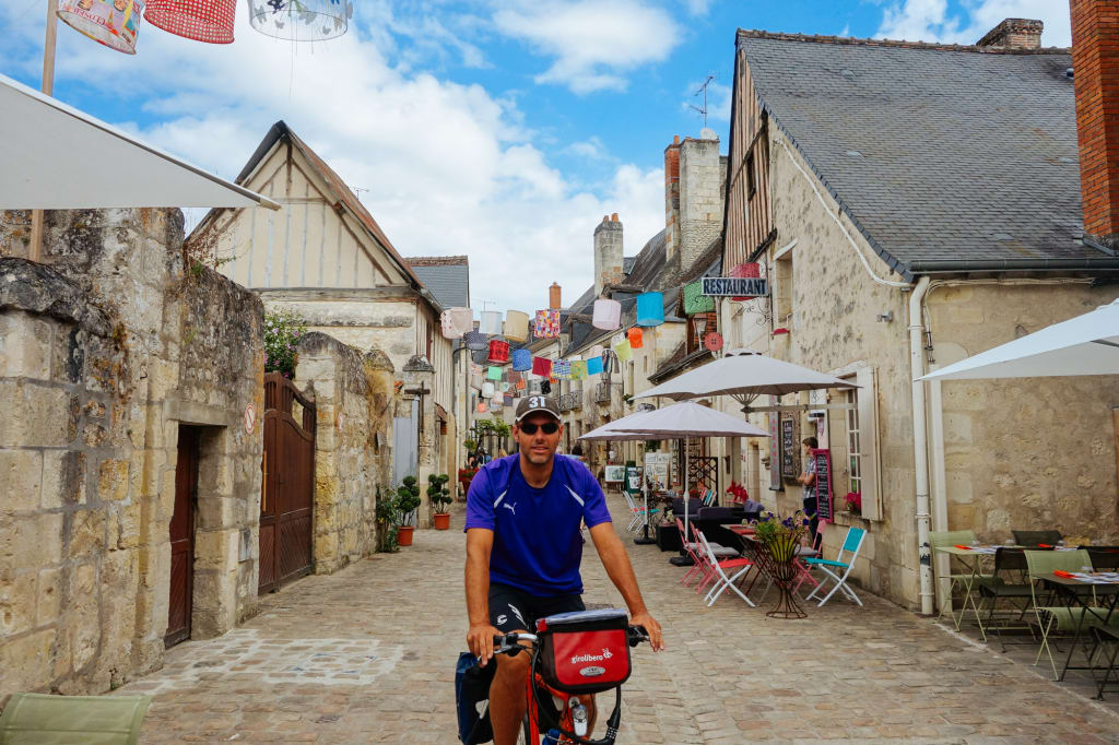 Cyclists in the historic center of Chinon, France.