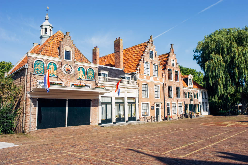 Piazza storica di Edam con edifici in mattoni rossi, celebre città olandese famosa per il formaggio.