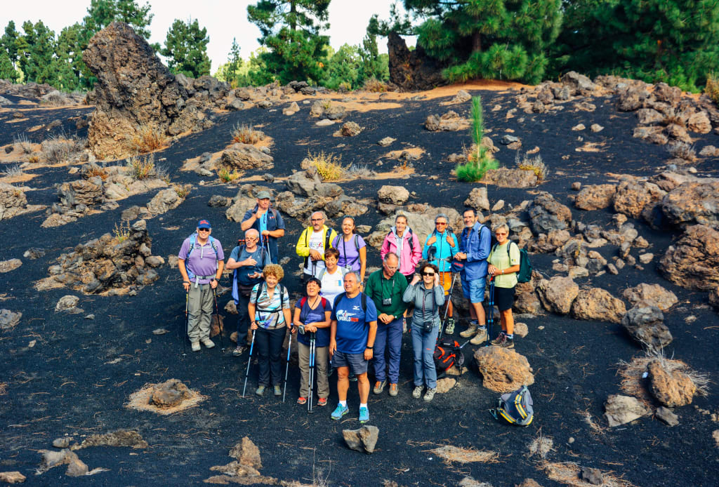 Gruppo di escursionisti in un paesaggio vulcanico a Tenerife, trekking tour alle Isole Canarie, Spagna